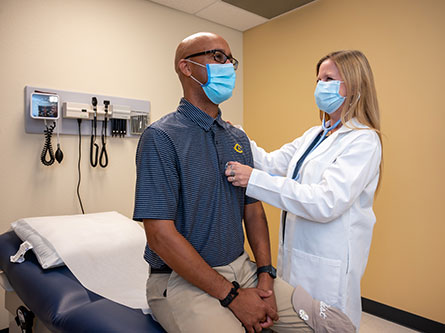 primary care provider listening to patient's heart