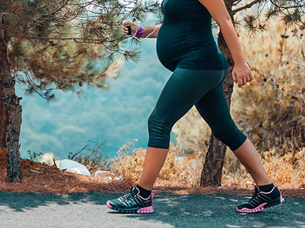 pregnant woman walking outside for pregnancy exercise