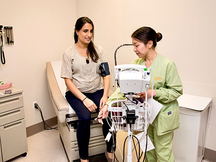 pregnant woman who has preeclampsia symptoms getting her blood pressure taken by a nurse